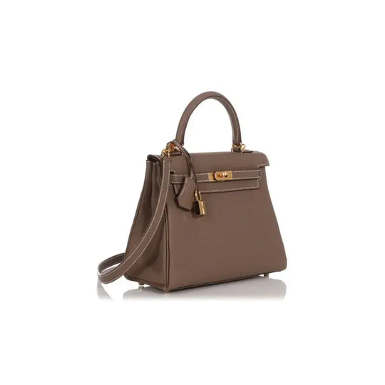 HERMES Kelly handbag in elephant gray Togo leather featuring elegant design and high quality. A stylish luxury bag for women.