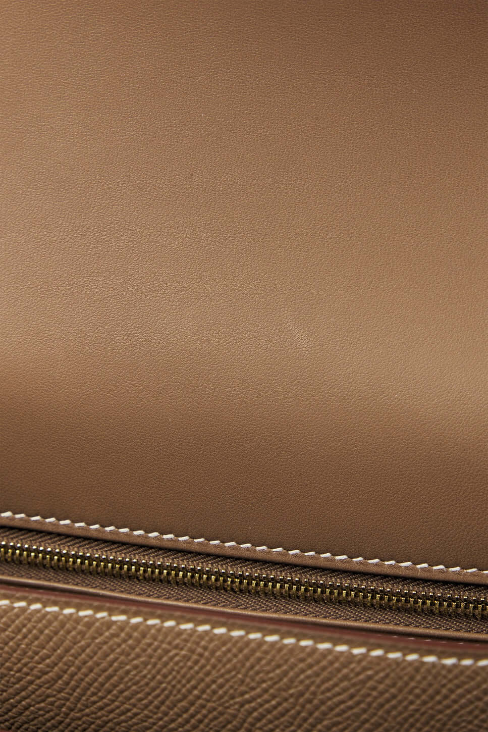 Hermès Constance Mini beige luxury bag with gold zipper detailing and classic stitching, perfect for stylish everyday use.