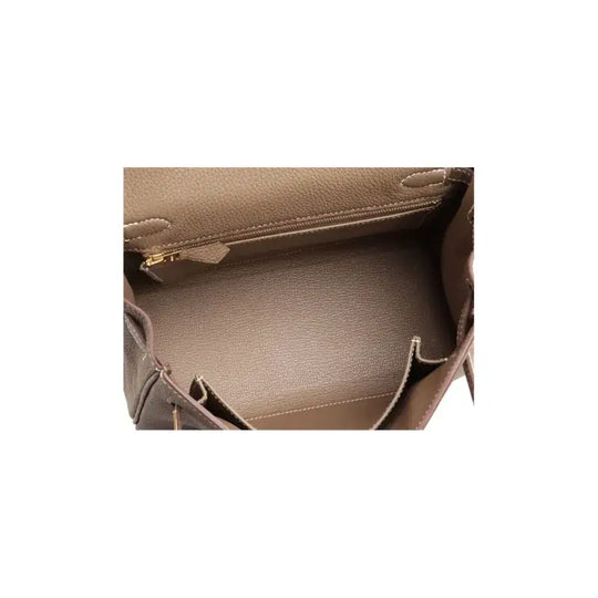 Interior view of Hermès Kelly elephant gray Togo leather handbag showcases spacious design, ideal as a luxury bag for women.