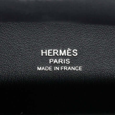 Hermès branding detail showing Paris and Made in France on luxurious black leather, symbolizing high quality in designer handbags.