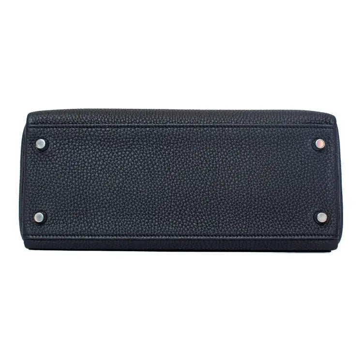 black leather handbag bottom view showcasing high-quality craftsmanship and durable hardware, ideal for everyday use.