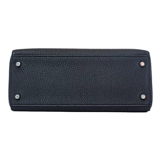 black leather handbag bottom view showcasing high-quality craftsmanship and durable hardware, ideal for everyday use.