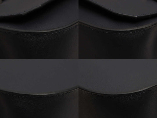 Black leather handbag featuring a smooth surface and elegant curved design, showcasing its high quality and stylish appeal.
