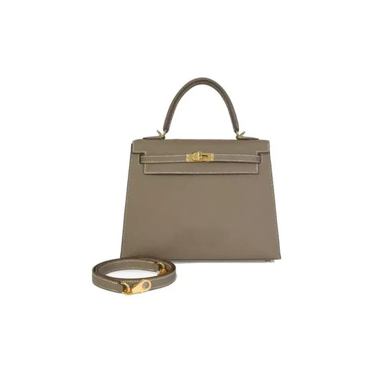Hermes Kelly Bag in elephant gray Epsom leather with gold hardware. Luxury bag for women, perfect for chic everyday style.