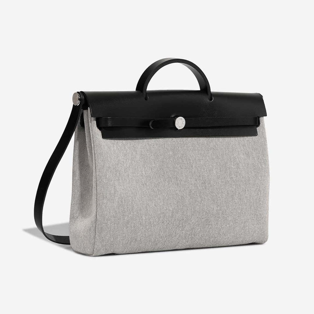 Hermes Herbag 31 designer handbag in black leather and gray canvas, stylish and versatile luxury bag for women, perfect for everyday use.
