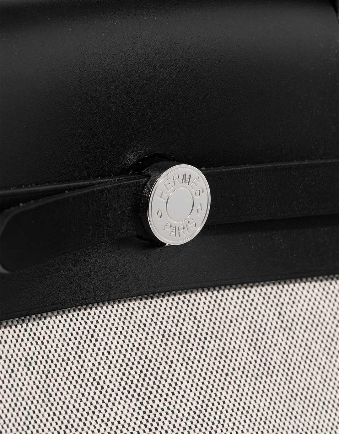 Hermes Herbag 31 bag close-up featuring silver hardware, black canvas and calfskin leather, luxury bag for women.