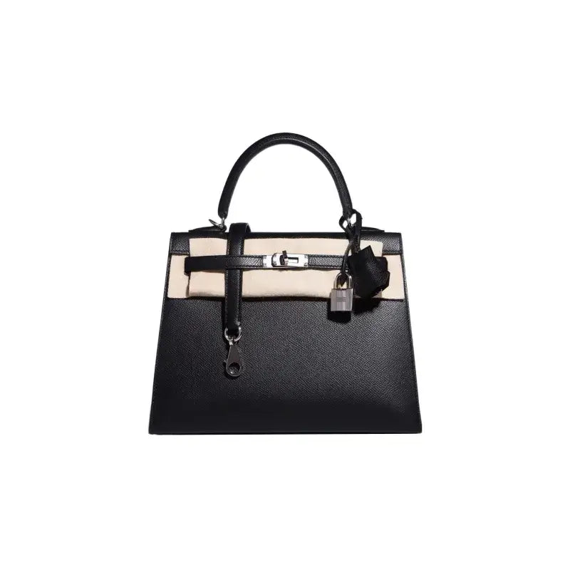 Black luxury handbag with elegant design, crafted from high quality leather, perfect for stylish women, timeless fashion accessory.