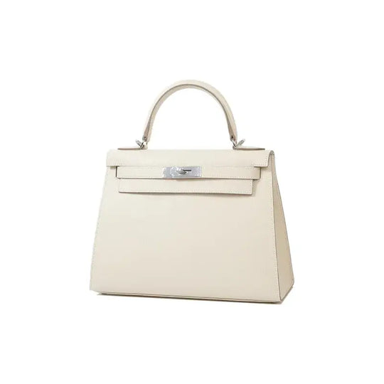 HERMES Kelly 25 Bag in Milkshake White Epsom Leather with silver hardware, a luxury bag for women showcasing timeless elegance.