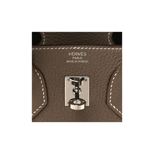 Hermes Birkin Bag Etoupe Elephant Gray leather lock detail showcasing luxury craftsmanship and designer elegance.