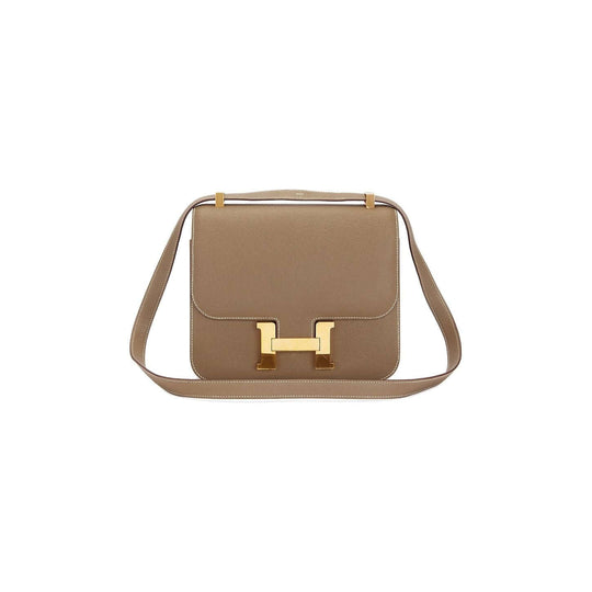 Hermès Constance Mini beige luxury bag for women featuring a gold-tone clasp, perfect for everyday elegance and style.