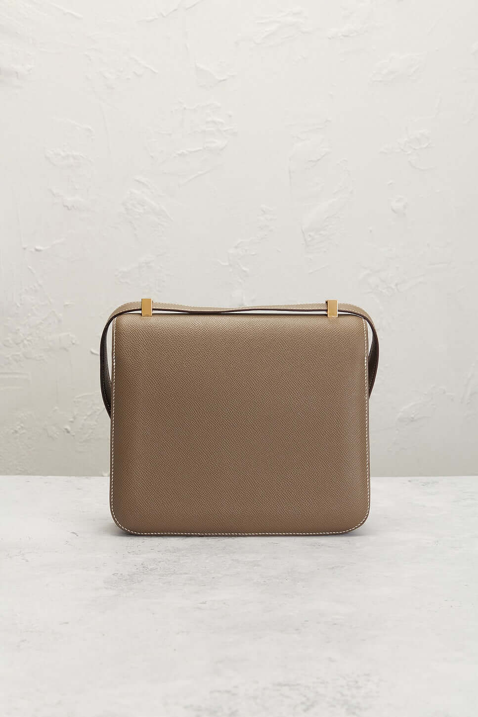 Hermès Constance Mini beige luxury bag for women featuring structured silhouette and signature clasp, a timeless fashion bag.