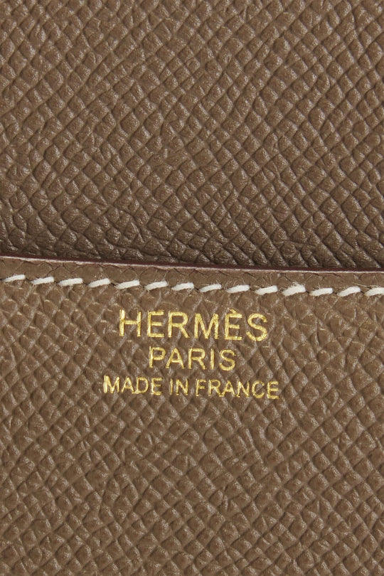 Hermès logo on beige leather, showcasing craftsmanship of luxury bag for women, highlighting Made in France quality.