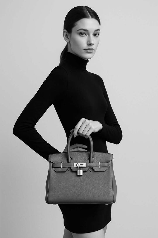 HERMES Birkin Bag in Etoupe Elephant Gray togo leather held by model, luxury bag for women, stylish and timeless fashion accessory.