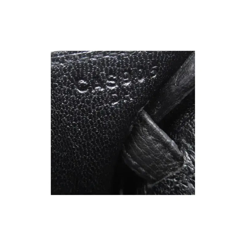 Hermes Birkin 25 black togo leather handbag interior with embossed brand marking, showcasing high quality craftsmanship.