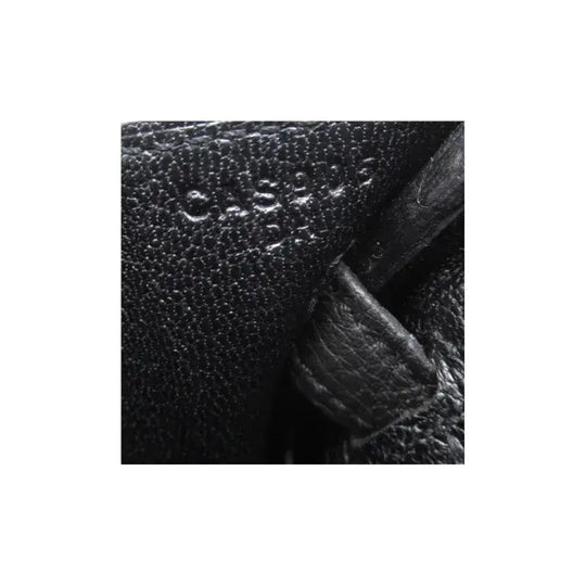 Hermes Birkin 25 black togo leather handbag interior with embossed brand marking, showcasing high quality craftsmanship.