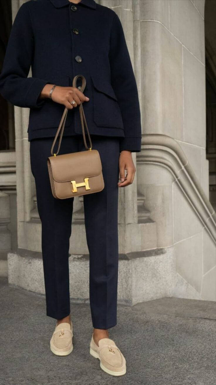 Elegant Hermès Constance Mini 18 in brown, paired with a stylish outfit, perfect luxury bag for women. High quality fashion accessory.
