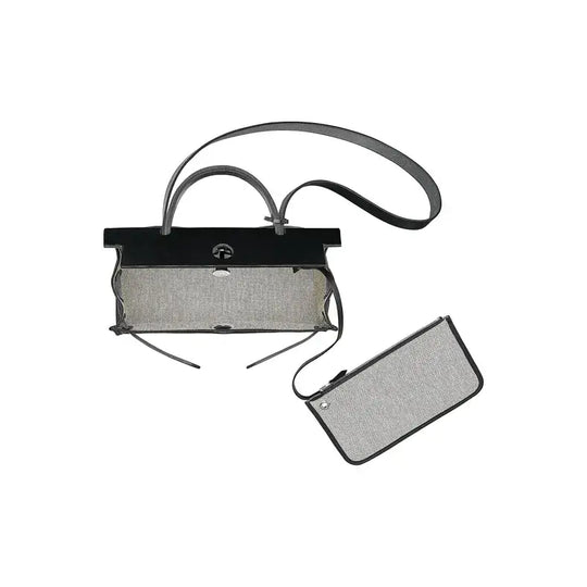 Hermes Herbag 39 shiny black luxury bag for women featuring sleek design, detachable pouch, and durable materials.