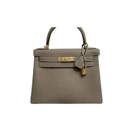 HERMES Kelly 25 handbag in elephant gray Togo leather, a luxury bag for women symbolizing timeless elegance and sophistication.