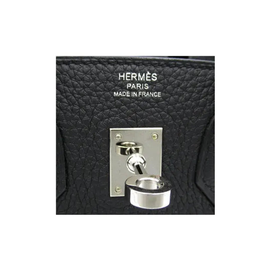 Hermes Birkin 25 black leather handbag lock detail showcasing luxury craftsmanship and high quality fashion accessory