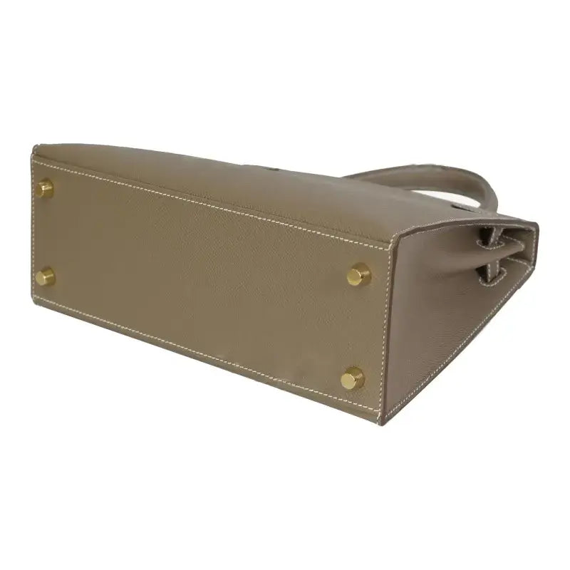 Hermès Kelly Bag in elephant gray Epsom leather showing base with gold hardware, a luxury bag for women and stylish purse.